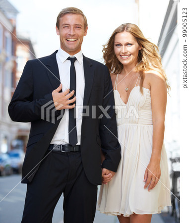 City date, valentines love and couple portrait with a smile ready for romance and happiness on a street. Suit, smile and happiness of a fancy woman and man together with care on dates for engagement 99005123