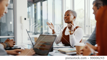 Meeting, discussion and professional black woman talking to her colleagues in the office conference room. Teamwork, presentation and African female employee in conversation with her team for project. 99006243