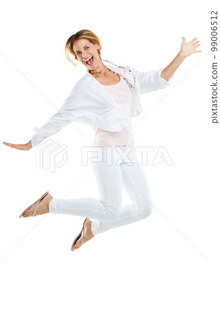 Woman, excited and jumping happy in studio for freedom, positive mindset energy and isolated in white background. Female, smile and jump in air for happiness motivation, celebration or winner success Woman, excited and jumping happy in studio for freedom, positive mindset energy and isolated in white background. Female, smile and jump in air for happiness motivation, celebration or winner success 99006512