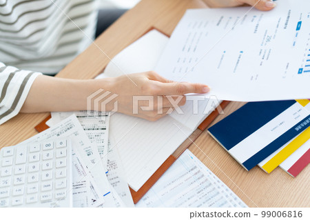 A woman checking her household budget for inflation 99006816