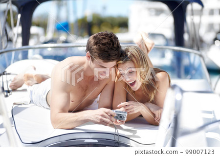 Couple relax on yacht for summer vacation, holiday or travel excited of picture, digital memory and real love. Happy young woman, partner or people on boat trip for valentines day celebration or date 99007123