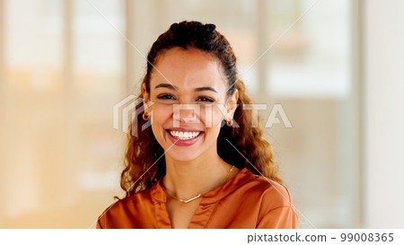 Latino business woman smiling and laughing with joy in an office. Portrait of a confident and ambitious young entrepreneur feeling motivated, empowered and optimistic for success in a startup company 99008365
