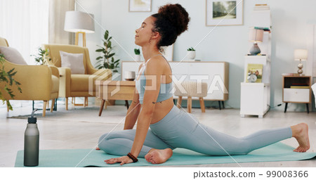 Fitness, yoga or meditation stretching woman for workout in the living room of her house. Girl with chakra focus, mindset or balance while training, exercise or health with zen pilates for wellness. 99008366
