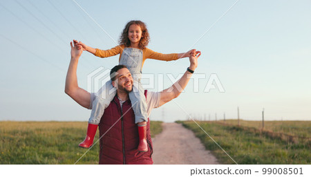 Happy family, father and child walking on a farm on a relaxed, calm and peaceful holiday vacation outdoors. Smile, happiness and young girl enjoys bonding and love having fun with dad in nature field Happy family, father and child walking on a farm on a relaxed, calm and peaceful holiday vacation outdoors. Smile, happiness and young girl enjoys bonding and love having fun with dad in nature field 99008501