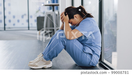 Healthcare, stress and sad nurse on floor with burnout, anxiety and headache working in emergency services. Medical care, mental health and health care worker with depression in hospital or clinic Healthcare, stress and sad nurse on floor with burnout, anxiety and headache working in emergency services. Medical care, mental health and health care worker with depression in hospital or clinic 99008781