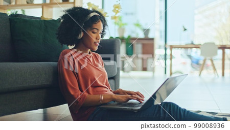 Black woman, laptop and singing with music headphones in house or home living room to dance audio, radio or podcast. Smile, happy or dancing student with technology for distance learning or education Black woman, laptop and singing with music headphones in house or home living room to dance audio, radio or podcast. Smile, happy or dancing student with technology for distance learning or education 99008936