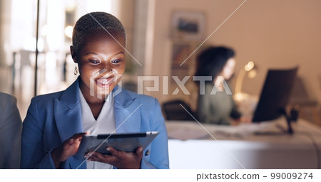 Business, night and black woman working on tablet in corporate office. Technology, internet and businesswoman doing overtime at work, busy with deadline. Online, tech and girl using digital notebook 99009274