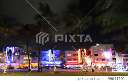 Night vibes at Ocean Drive, Art Deco Historic District in Miami Beach with illuminated hotels  99011591