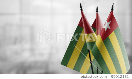 Small flags of the Togo on an abstract blurry background 99012181