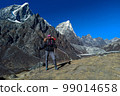 Hiker woman posing with mountains at background 99014658
