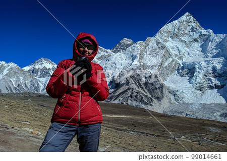 Hiker woman posing with mountains at background 99014661
