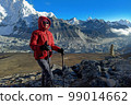 Hiker woman posing with mountains at background 99014662
