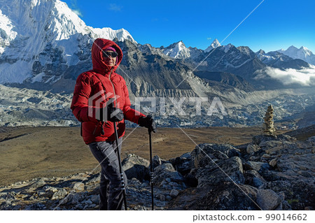 Hiker woman posing with mountains at background Hiker woman posing with mountains at background 99014662