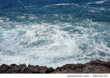 Raging waves crash against the rocky shore of the bay Intsekum Natural Park in Turkey. Selective focus. Close-up Raging waves crash against the rocky shore of the bay Intsekum Natural Park in Turkey. Selective focus. Close-up 99016259