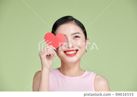 Love symbol. Beautiful girl holding a heart, office manager concept shot 99016555