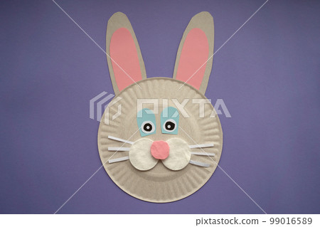 Easter card handmade. Step by step photo instruction. Children's art project. DIY concept. Very Peri background color. Top view, Flat lay. Step 4. Rabbit is ready. 99016589