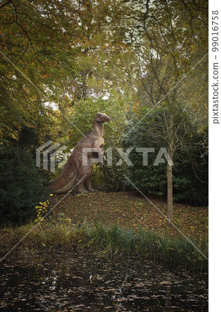 A life-size dinosaur model in an amusement park. A huge dinosaur in a zoo. A prehistoric herbivorous predator in the modern forest. Jurassic Park, prehistoric activities and attractions 99016758