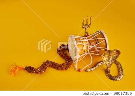 Shivaratri background with Shivas trident, Pellet Drum Damroo musical instrument ans snake . Maha Shivratri festval 99017399