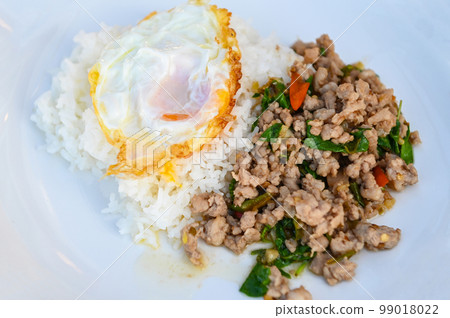 holy basil minced pork, Stir fried Thai basil with minced pork and a fried egg on white plate 99018022