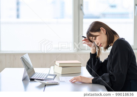 Asian woman worried about tax return Asian woman worried about tax return 99018636