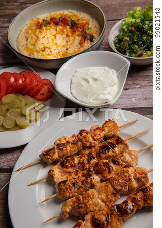 Lebanese recipe of chich taouk, garlic cream, toum, in a Lebanese bread, tabbouleh and chickpea Lebanese recipe of chich taouk, garlic cream, toum, in a Lebanese bread, tabbouleh and chickpea 99021548