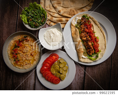 Lebanese recipe of chich taouk, garlic cream, toum, in a Lebanese bread, tabbouleh and chickpea 99021595