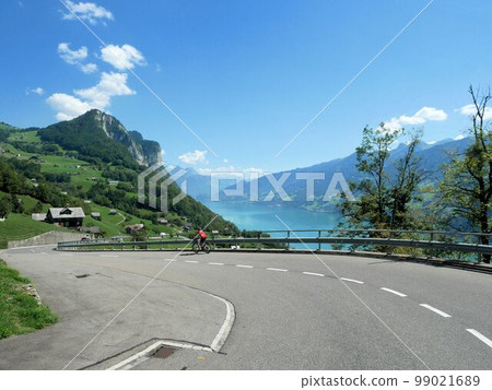 Riding a bicycle in the Swiss Alps (Canton of Amden St.Gallen) Riding a bicycle in the Swiss Alps (Canton of Amden St.Gallen) 99021689