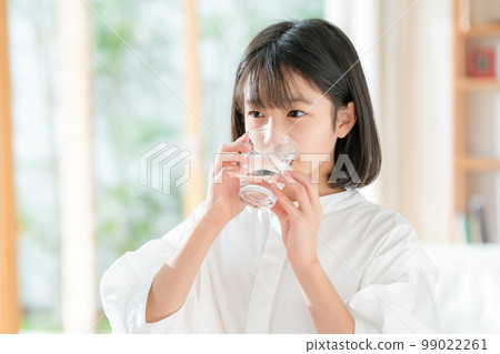 A girl drinking water 99022261