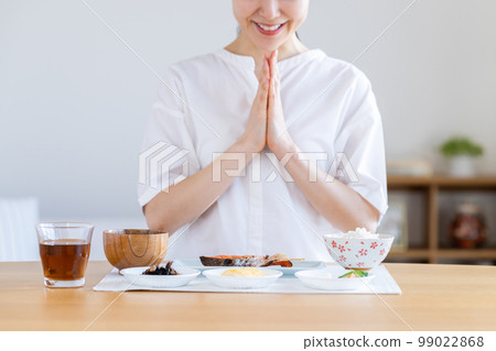 Young woman eating breakfast 99022868