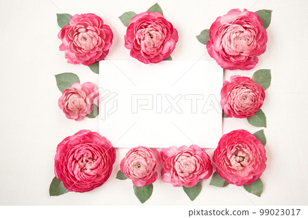 Love letter. white card with pink paper envelope mock up. Petals of flowers, roses and ranunculus. Valentine's day romantic background . Space for text. 99023017