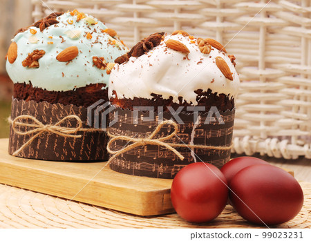 Easter eggs and cakes with icing, nuts and anise stars 99023231