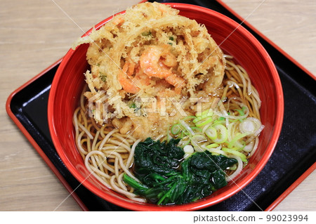 Standing Eating Soba Noodles with Shrimp Kakiage 99023994