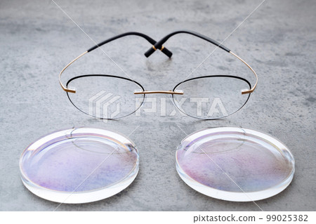 New lenses and frame for eyeglasses production lying on table in optic 99025382