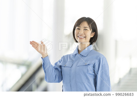 Portrait of a young woman in work clothes looking at the camera 99026683