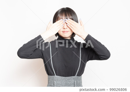 young woman covering her eyes young woman covering her eyes 99026806