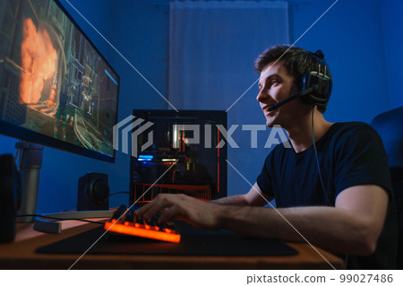 Young cyber sportsman playing videogame on computer 99027486