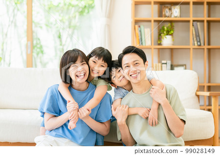 A family relaxing in the living room 99028149