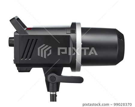 Powerful modern studio flash with a protective cap on the lamp, isolated on a white background. Side view. Studio shooting. Powerful modern studio flash with a protective cap on the lamp, isolated on a white background. Side view. Studio shooting. 99028370