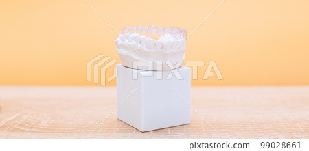 Orthodontic dental theme on yellow background.Transparent invisible dental aligners or braces aplicable for an orthodontic dental treatment Orthodontic dental theme on yellow background.Transparent invisible dental aligners or braces aplicable for an orthodontic dental treatment 99028661