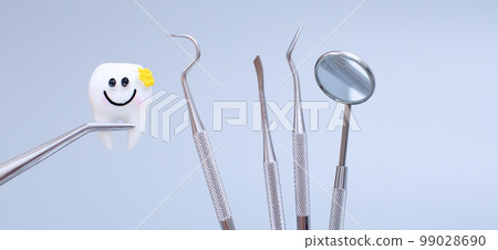 Dental tools and model of teeth on a blue background. Dental care concept. Invisible braces 99028690