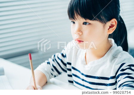 An elementary school girl studying at a cram school. An elementary school girl studying at a cram school. 99028754