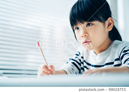 An elementary school girl studying at a cram school. An elementary school girl studying at a cram school. 99028755