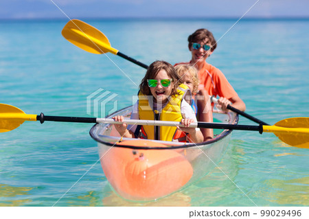 Kids kayaking in ocean. Family in kayak in tropical sea 99029496