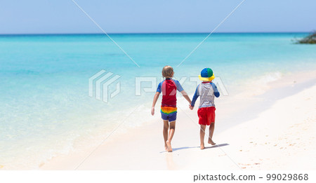 Kids playing on beach. Children play at sea. Kids playing on beach. Children play at sea. 99029868