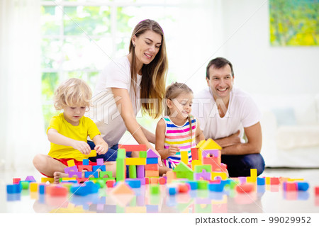 Kids play with toy blocks. Family at home. Kids play with toy blocks. Family at home. 99029952