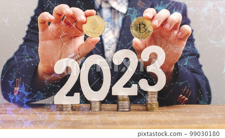 Businessman thinking about investing in cryptocurrency in 2023, choice between Ethereum and Bitcoin against the background of the chart 99030180