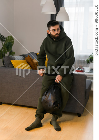 Sad man pondering about his life after a relationship breakup or bipolar disorder - depression asthenia , mental problem and anxiety disorder concept 99030310
