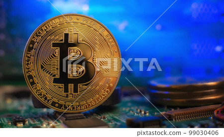 Cryptocurrency concept , Golden bitcoin on mainboard , The future of money. Computational equipment. Cryptocurrency concept , Golden bitcoin on mainboard , The future of money. Computational equipment. 99030406