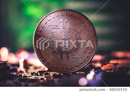 Cryptocurrency concept , Golden bitcoin on mainboard , The future of money. Computational equipment. Cryptocurrency concept , Golden bitcoin on mainboard , The future of money. Computational equipment. 99030559