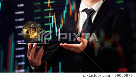Smartphone with Bitcoin trading chart . Holding in hand a gold Bitcoin Cash coin. Trading on the cryptocurrency exchange. 99030976